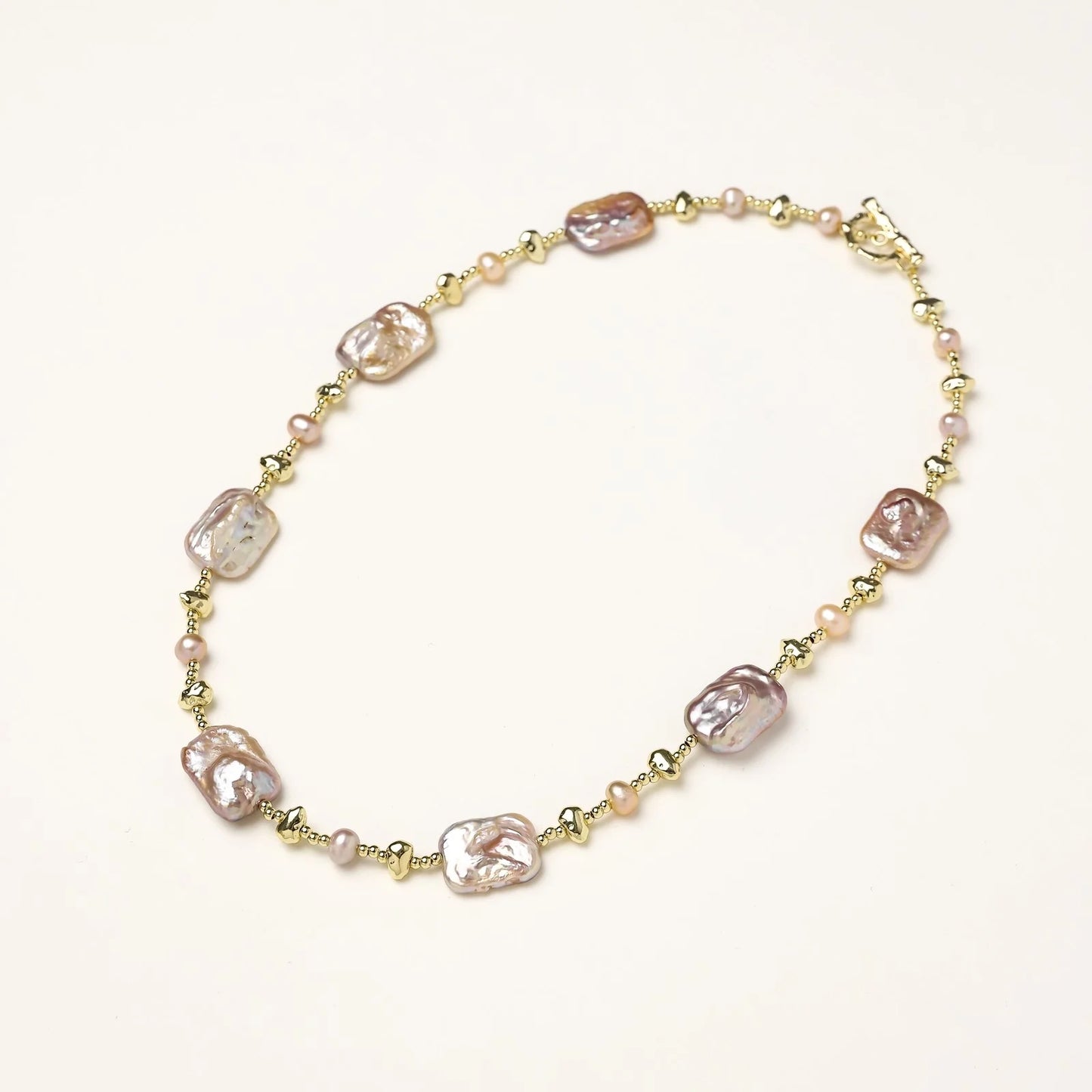 Iridescent baroque pearls alternating with small freshwater pearls on 14K gold-plated chain