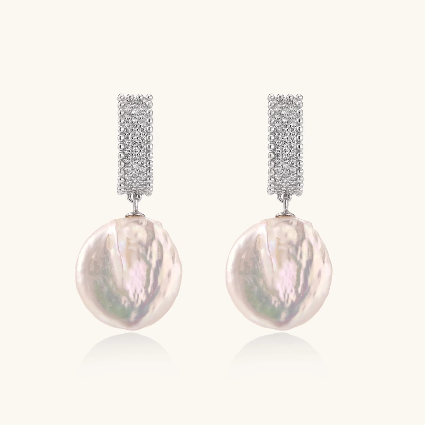 Rhodium-plated silver curved stud with pave stones and baroque pearl drop on white background