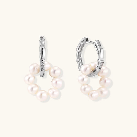 Rhodium-plated silver hoop earrings with freshwater pearls arranged in crescent formation and diamond accents