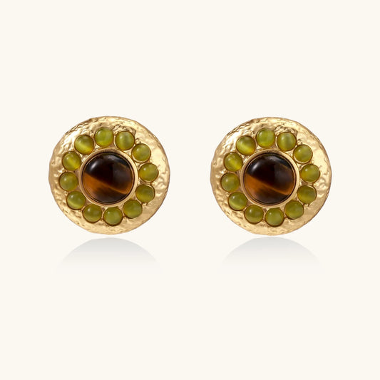 Round hammered gold studs with brown tiger's eye center surrounded by olive green liuli stones on white background.