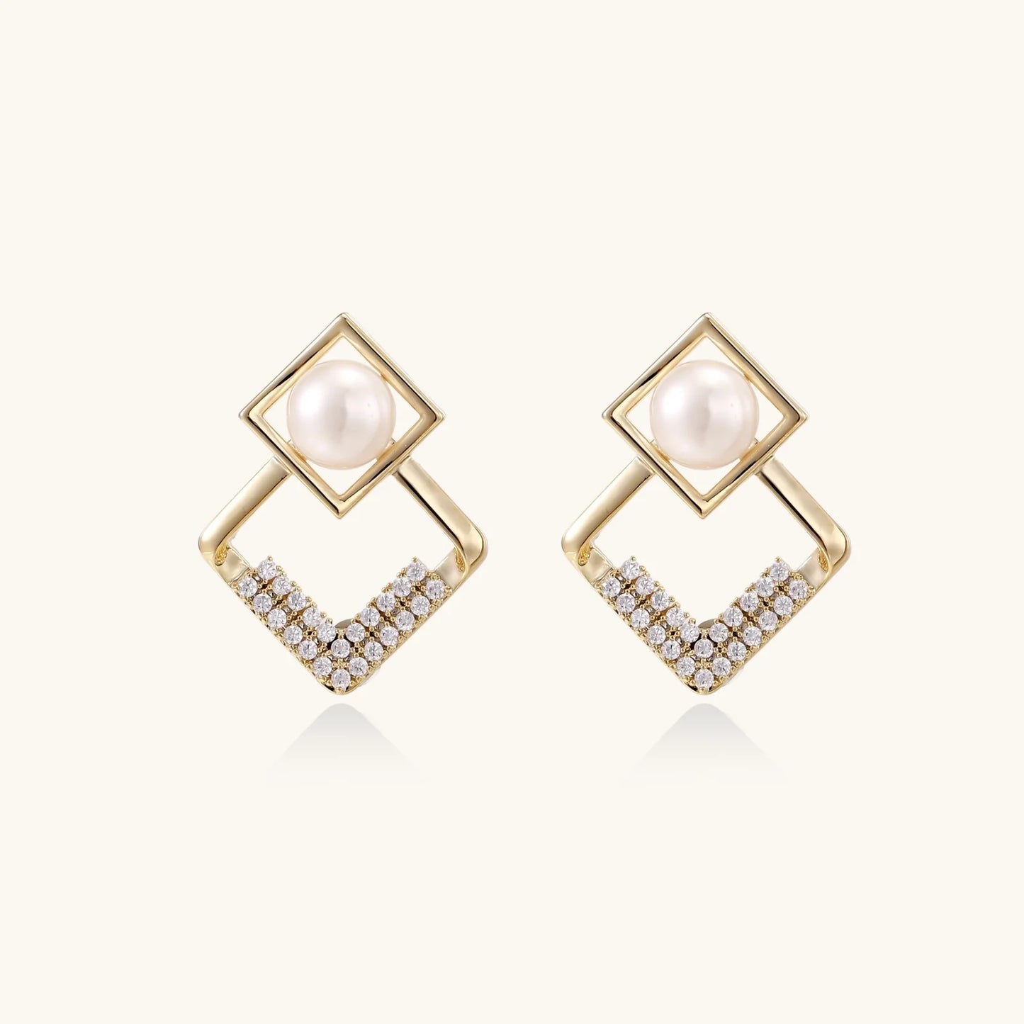 Gold-plated double square frame earrings with freshwater pearl and crystal accents on white background